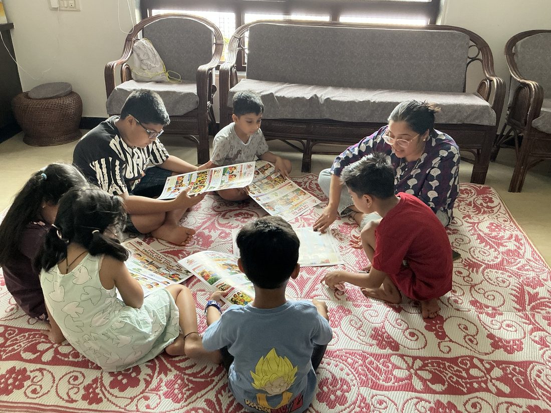 Children reading Tricolour charts together with Mamta