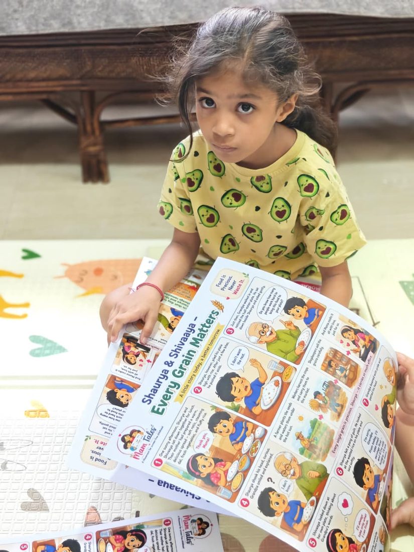 A girl holding the Every Grain Matters chart